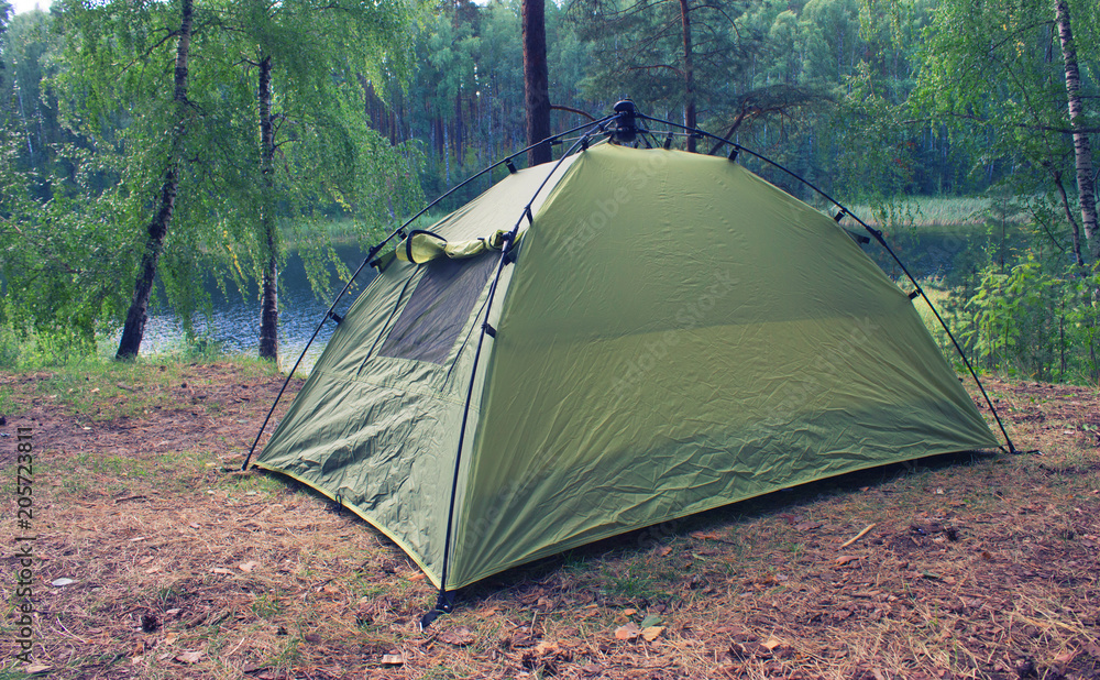 green tents are in the forest