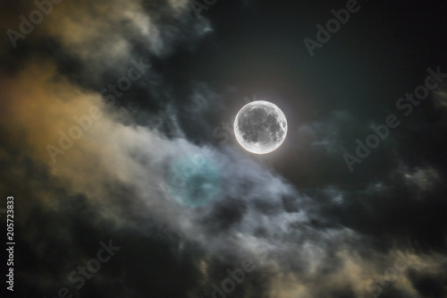 full night moon shines alone in sky clouds