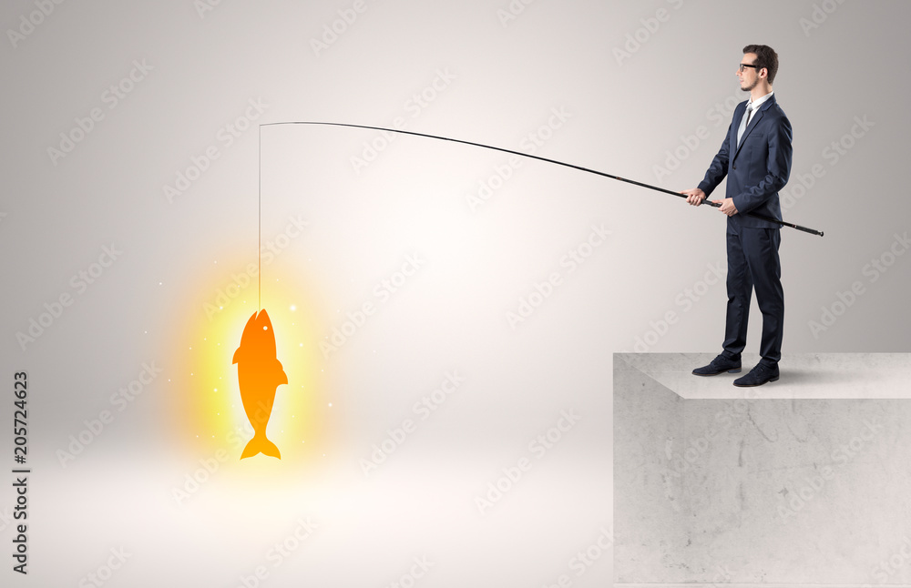 Young businessman fishing golden fish from the top of a building
Young businessman fishing golden fish from the top of a building