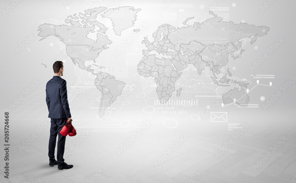 Businessman standing with his back and looking at a worldwide map with objects in his hand
Businessman standing with his back and looking at a worldwide map with objects in his hand