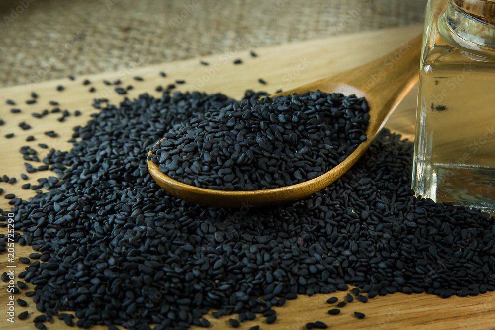 black Sesame seeds on a old wooden table. black Sesame seeds on a old wooden table.