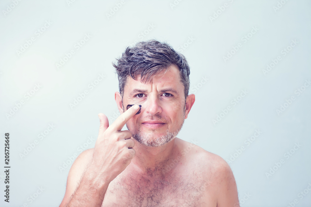 Naklejka premium Handsome man with black face mask on his face