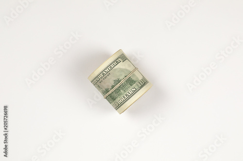 100 dollar bill roll isolated on white background.