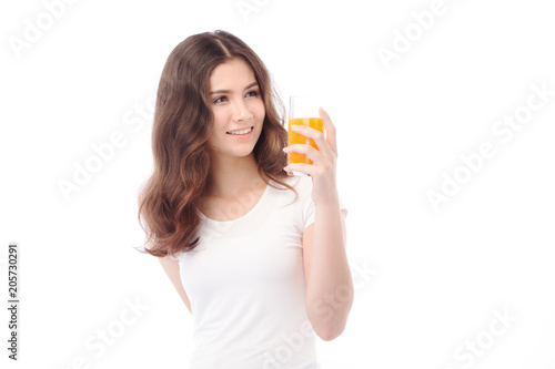 Portrait of a woman drinking orange juice. Orange juice in glass