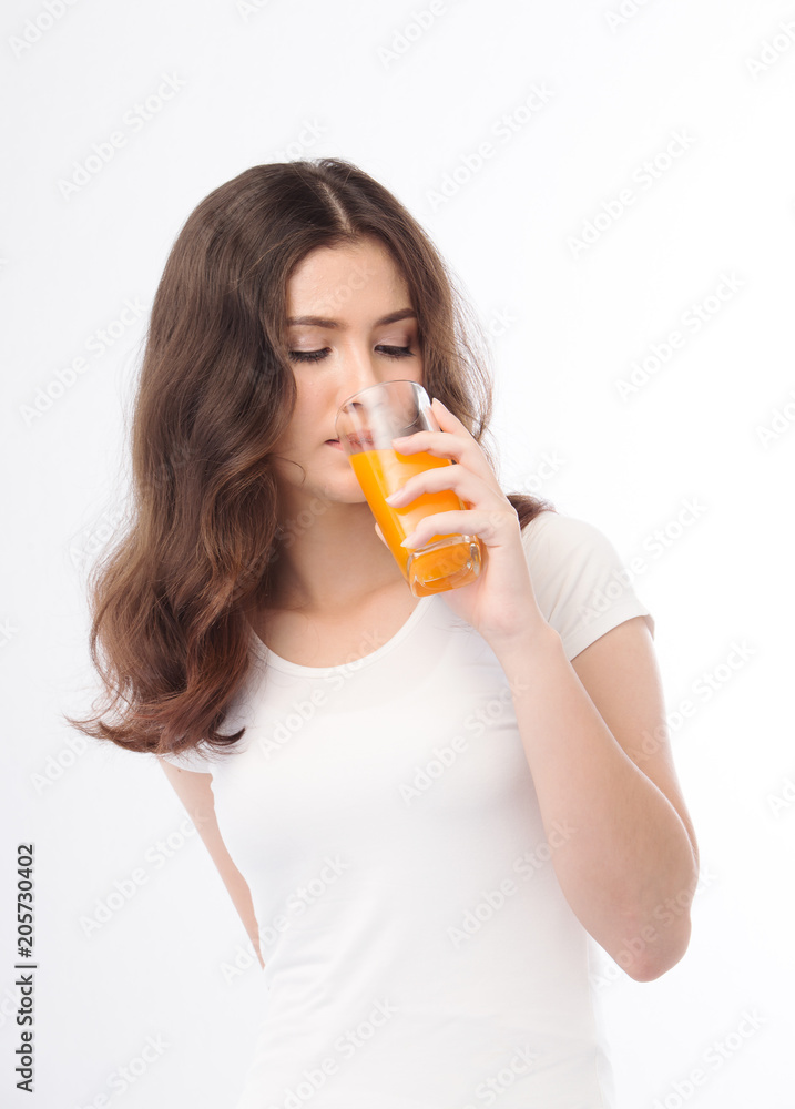 Portrait of a woman drinking orange juice. Orange juice in glass Portrait of a woman drinking orange juice. Orange juice in glass