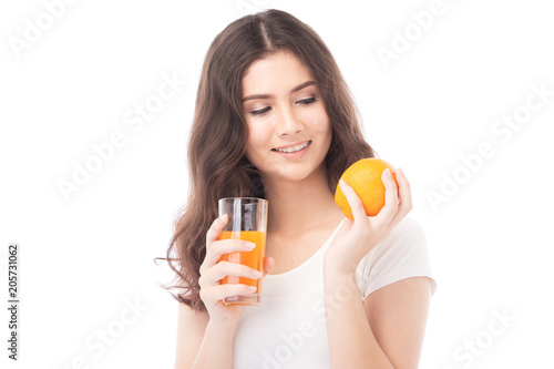 Portrait of a woman drinking orange juice. Orange juice in glass