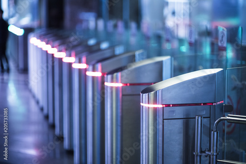 Glowing Turnstiles on an entrance to the subway photo
