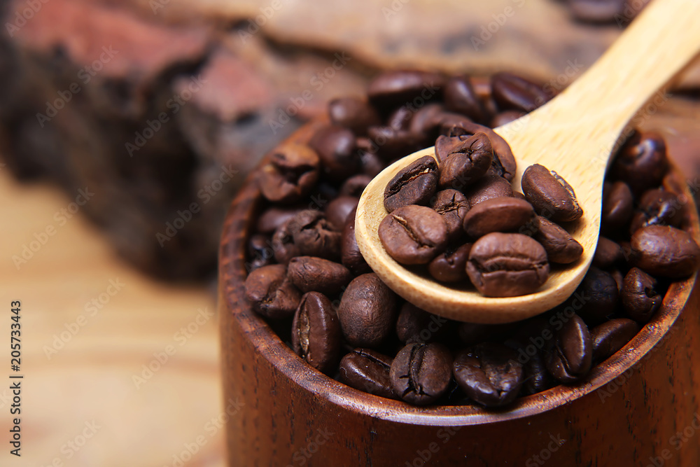 close-up various kinds of coffee beans scattered on a wooden background, ground coffee, wooden spoon empty space for text, macro, set close-up various kinds of coffee beans scattered on a wooden background, ground coffee, wooden spoon empty space for text, macro, set