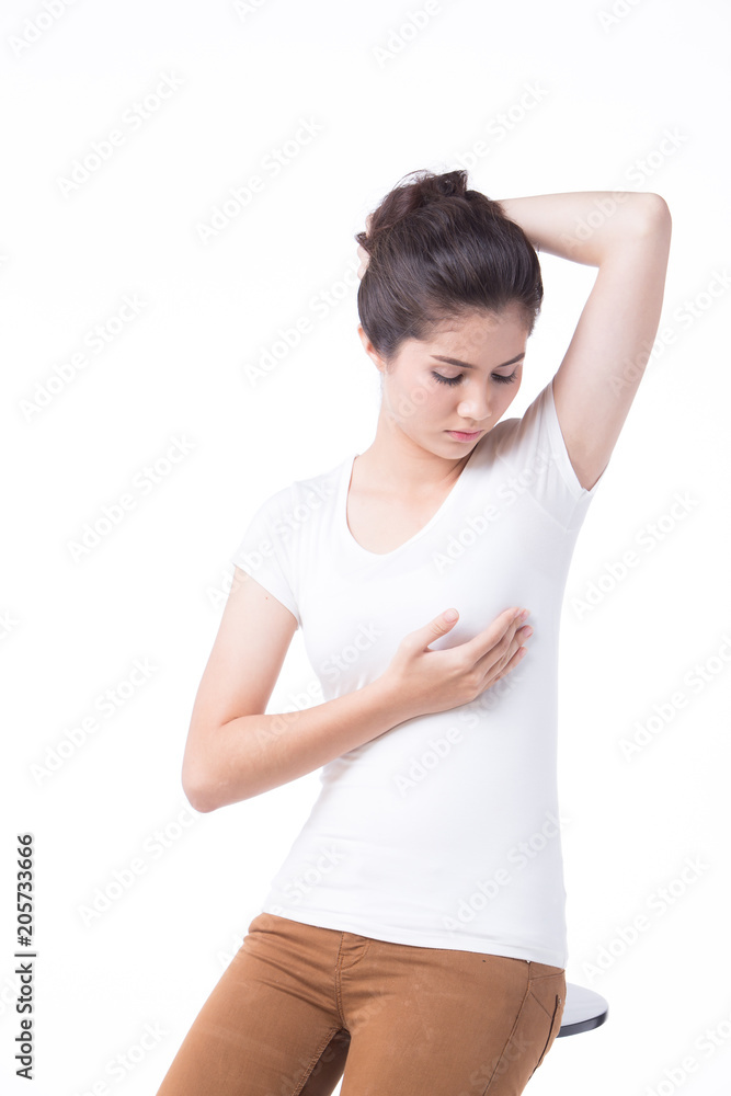 Woman testing her breast for cancer flattening the tissue with one hand and manipulating to detect lumps with the fingers on her other hand Woman testing her breast for cancer flattening the tissue with one hand and manipulating to detect lumps with the fingers on her other hand