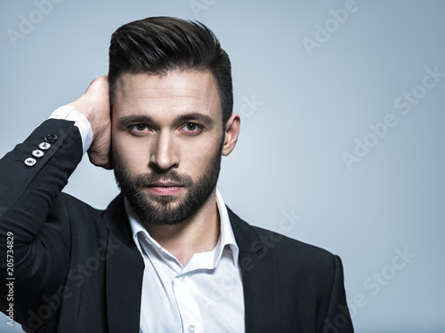 Handsome man in black suit with white shirt