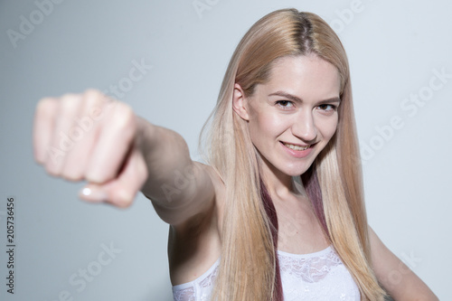 Portrait of a beautiful blonde posing on a light background