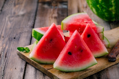 Fresh sliced watermelon on wooden rustic background