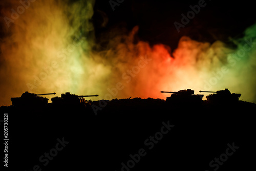 War Concept. Military silhouettes fighting scene on war fog sky background, World War German Tanks Silhouettes Below Cloudy Skyline At night. Attack scene. Armored vehicles. Tanks battle. Close up