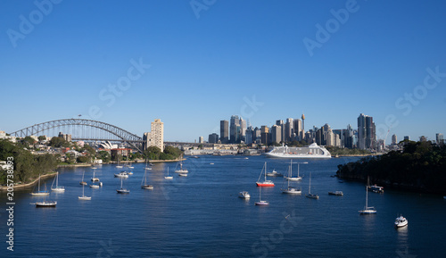 view of city in Sydney with waterfront and cruise on harbour, in clear blue sky day