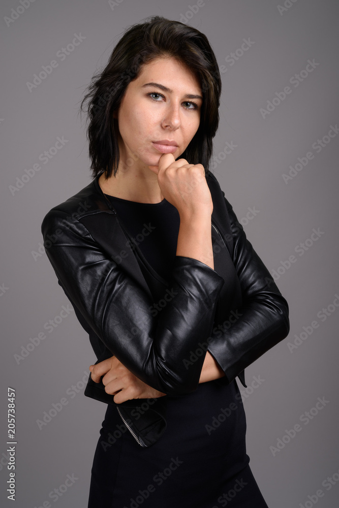 Fototapeta premium Young beautiful woman against gray background