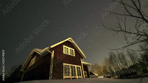 winter otating star sky whole night timelapse filmed in the garden behind swedish wood house photo