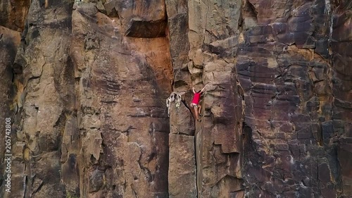 Slow motion of man climbing a rock wall in a canyon - Climber training outdoor in a rocky spot - Travel, adrenaline and extreme dangerous sport concept