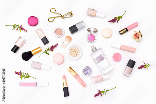 Set of decorative cosmetics of pink color on a white background. View from above