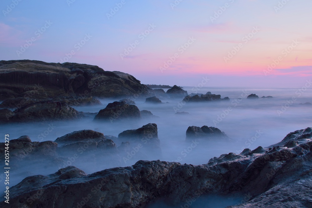 Dusk Landscape of island with long exposure moving sea waves