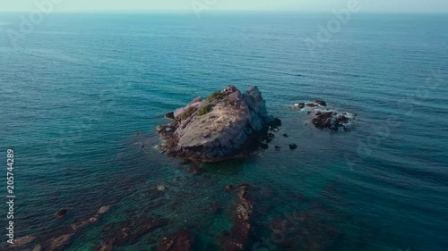 A huge stone in the middle of the sea, an amazing landscape, a flyover from the Copter.