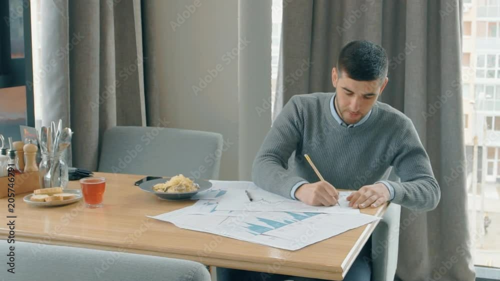Portrait of successful businesman working on financial report in cafe and looking to the window. Concept of: business peope, cafe table, modern interior, charts and graphs, financial planning Portrait of successful businesman working on financial report in cafe and looking to the window. Concept of: business peope, cafe table, modern interior, charts and graphs, financial planning