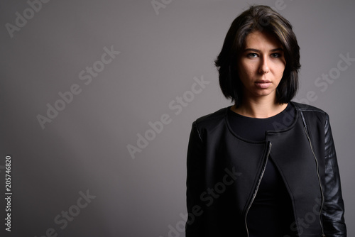 Young beautiful woman against gray background