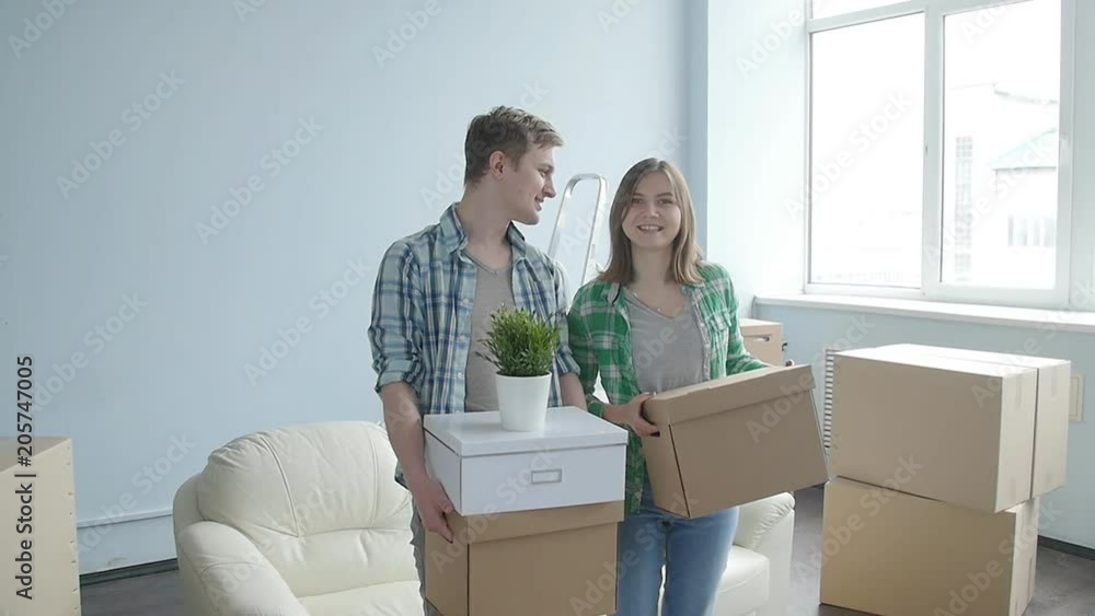 Smiling Young couple moves to a new apartment Smiling Young couple moves to a new apartment
