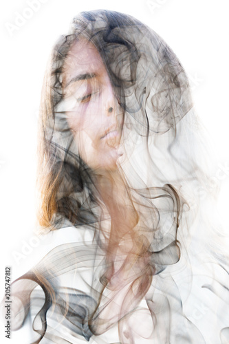 Fototapeta Naklejka Na Ścianę i Meble -  Double exposure portrait of a sensual model combined with a smoky texture behind which she hides or dissolves