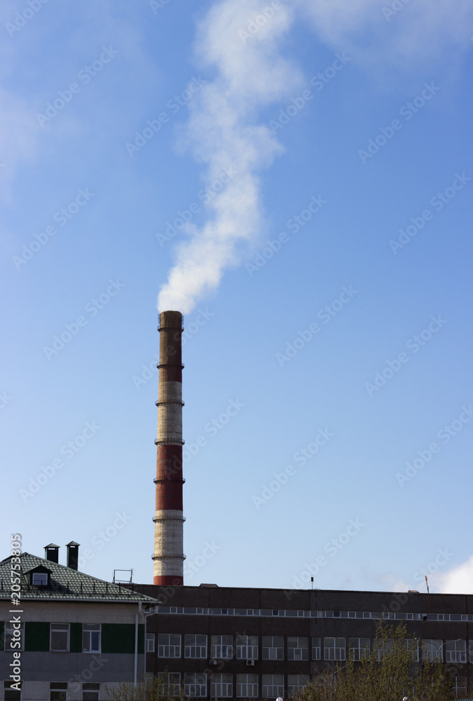 Factory chimney with smoke against the sky, pollution concept