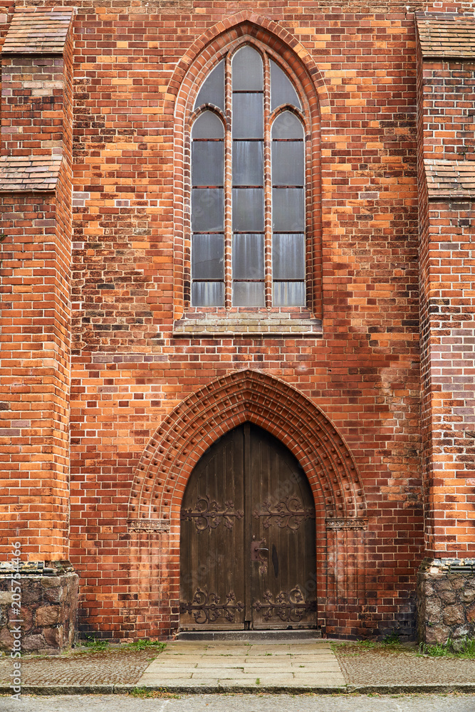 Portal and wooden doors of a medieval church in the city of Frankfurt (Oder).