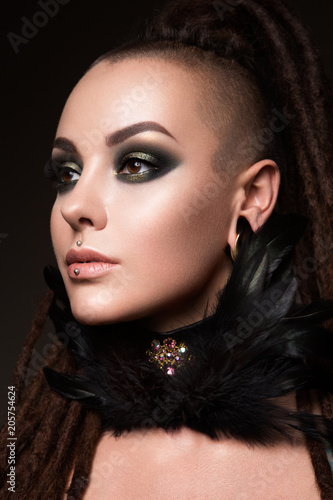 Close-up portrait of beautiful woman with bright make-up and hairstyle.