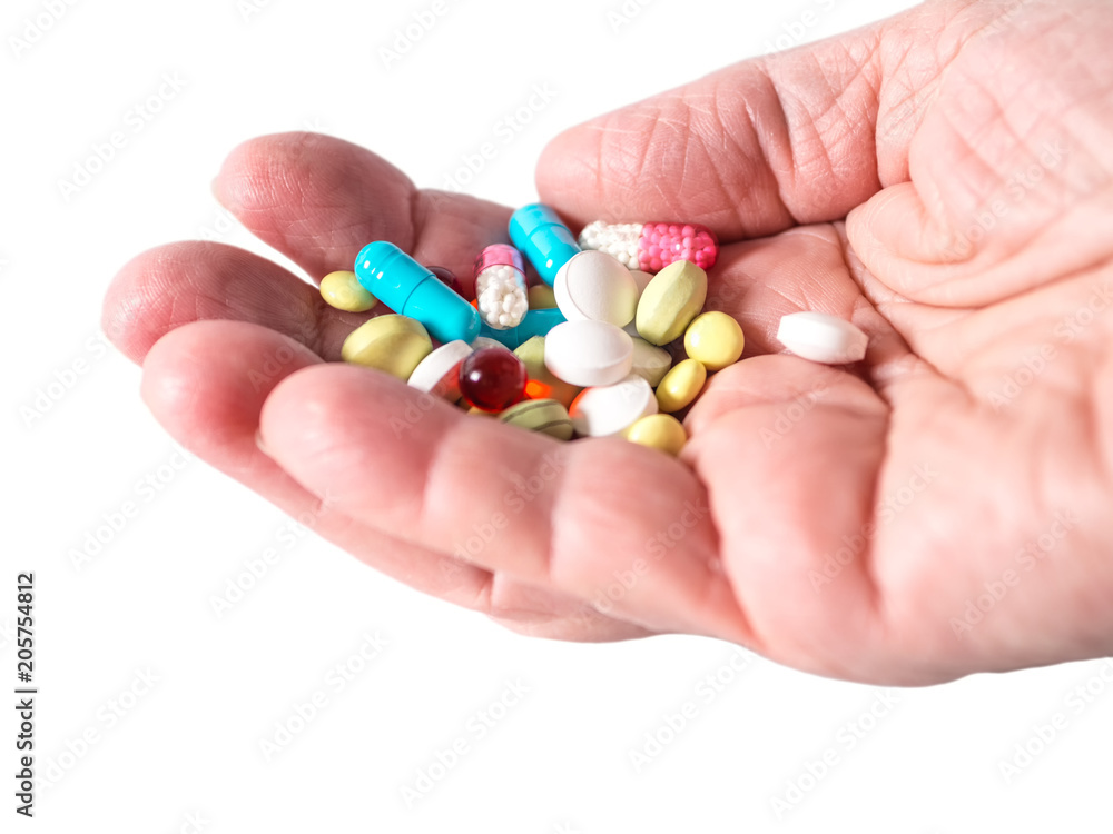 Pills and capsules on palm isolated on white background Pills and capsules on palm isolated on white background