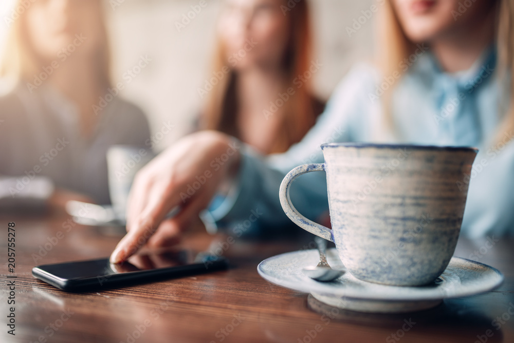Cup of coffee and phone on wooden table, closeup Cup of coffee and phone on wooden table, closeup
