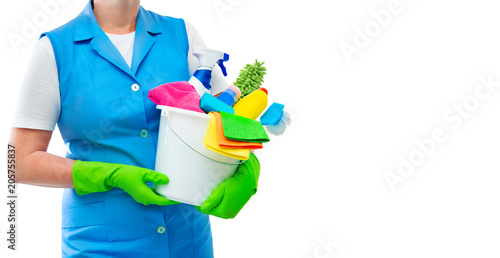 Female cleaner holding a bucket with cleaning supplies isolated on white