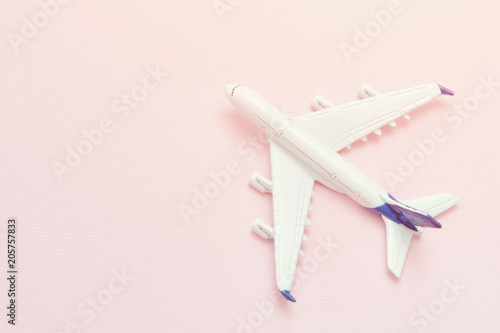 Airplane on a pink background. Place for text. Close-up