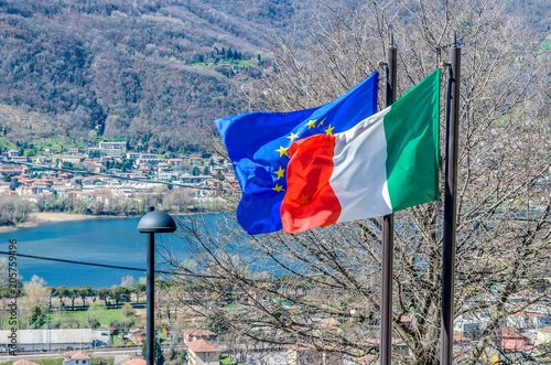 Italian and European flags waving in a sunny day photo