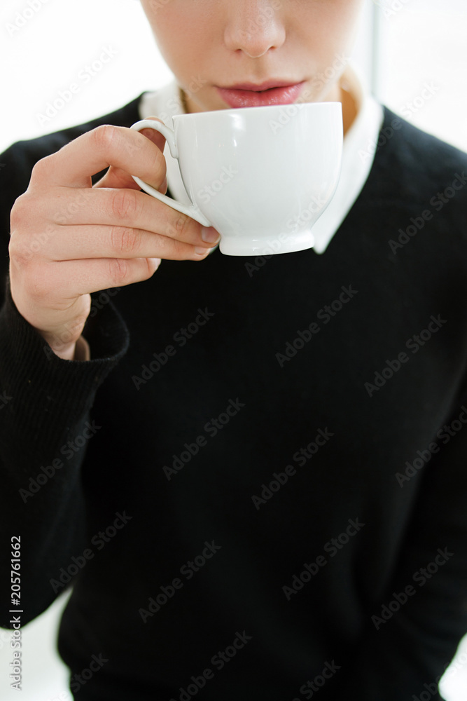 hot drinks coffee tea cocoa concept. woman drinking some beverage from a white cup. hot drinks coffee tea cocoa concept. woman drinking some beverage from a white cup.