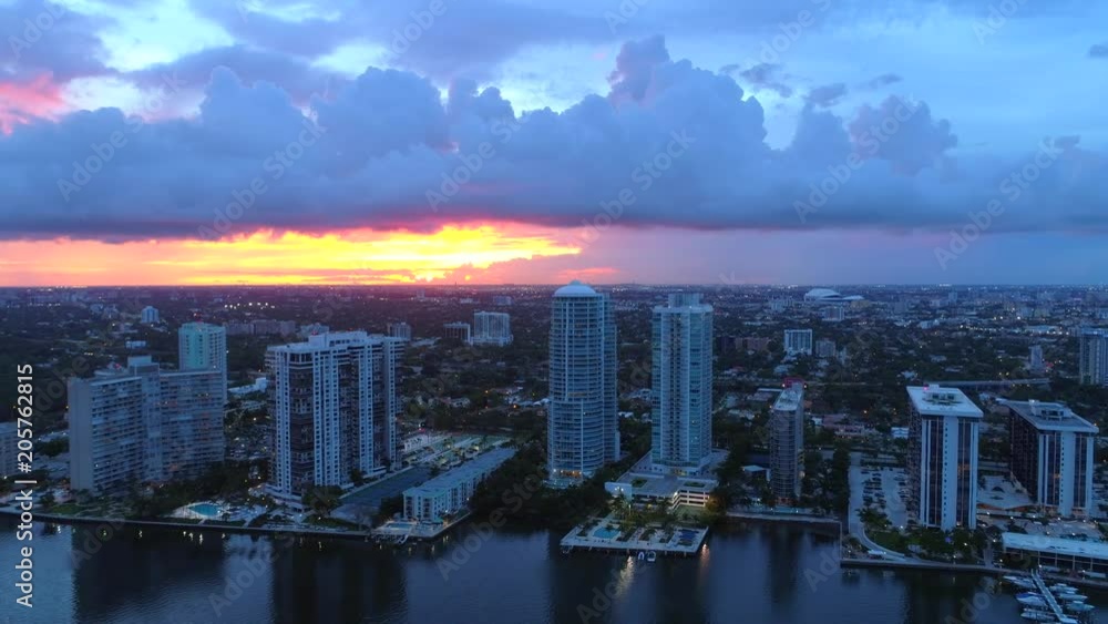 Aerial approach sunset and tall buildings in city Aerial approach sunset and tall buildings in city