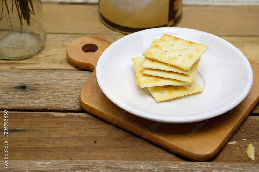 saltine crackers on white plate saltine crackers on white plate