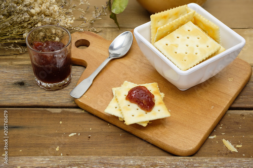 delicious saltine crackers spread with strawberry jam photo