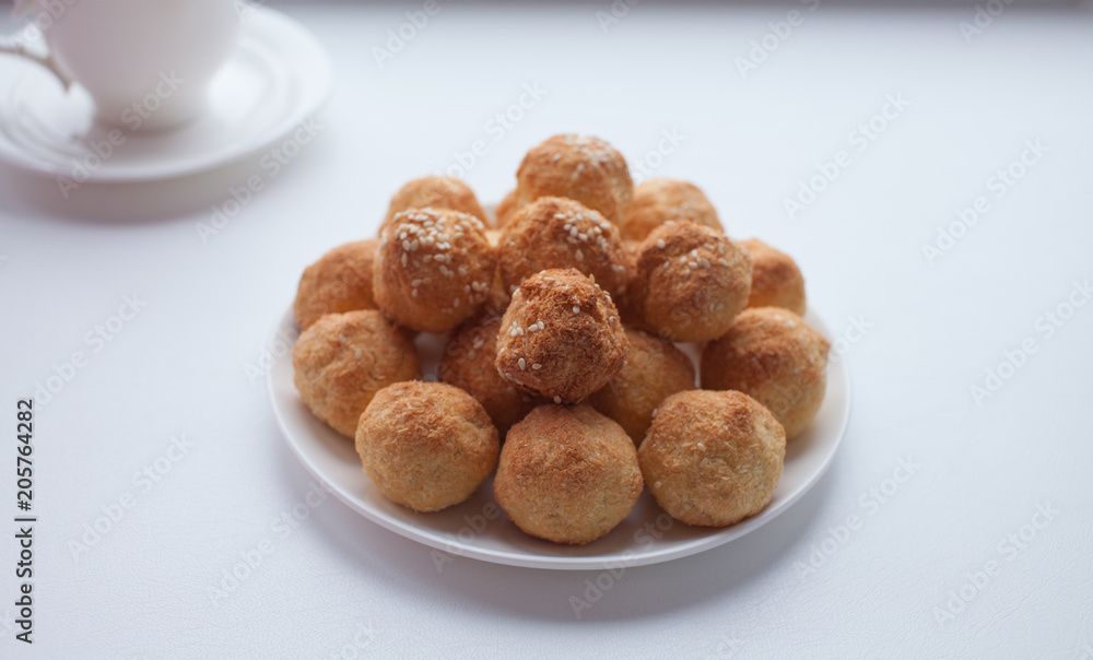 Plate with delicious coconut macaroons on table
