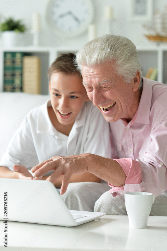 portrait of boy and grandfather with a laptop portrait of boy and grandfather with a laptop