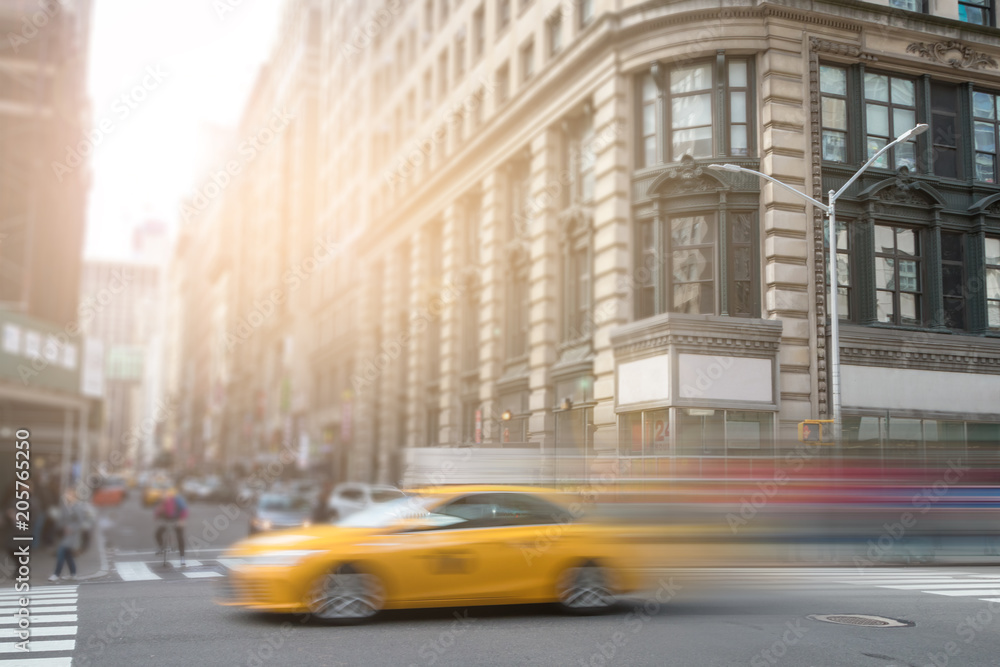 New York City yellow taxi speeding through Manhattan street