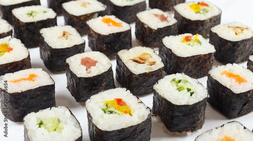Assorted japanese sushi on a white background close up. Assorted japanese sushi on a white background close up.