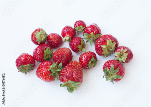 Heap of fresh strawberries on white background.