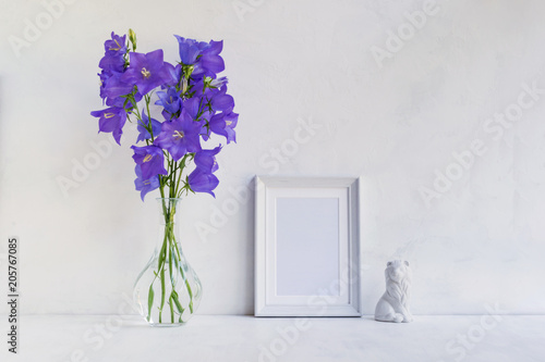 Fototapeta Naklejka Na Ścianę i Meble -  Mockup with a white frame and summer blue flowers