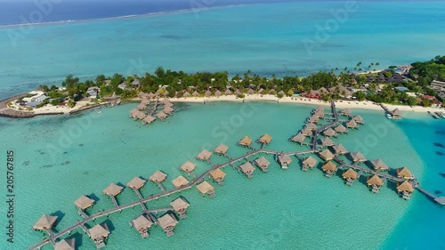 Aerial view of tropical paradise of Bora Bora island, turquoise crystal clear water of scenic blue lagoon, typical over water bungalows, Matira Point - South Pacific Ocean, French Polynesia from above photo