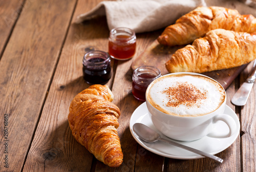 Breakfast with cup of cappuccino coffee with croissants
