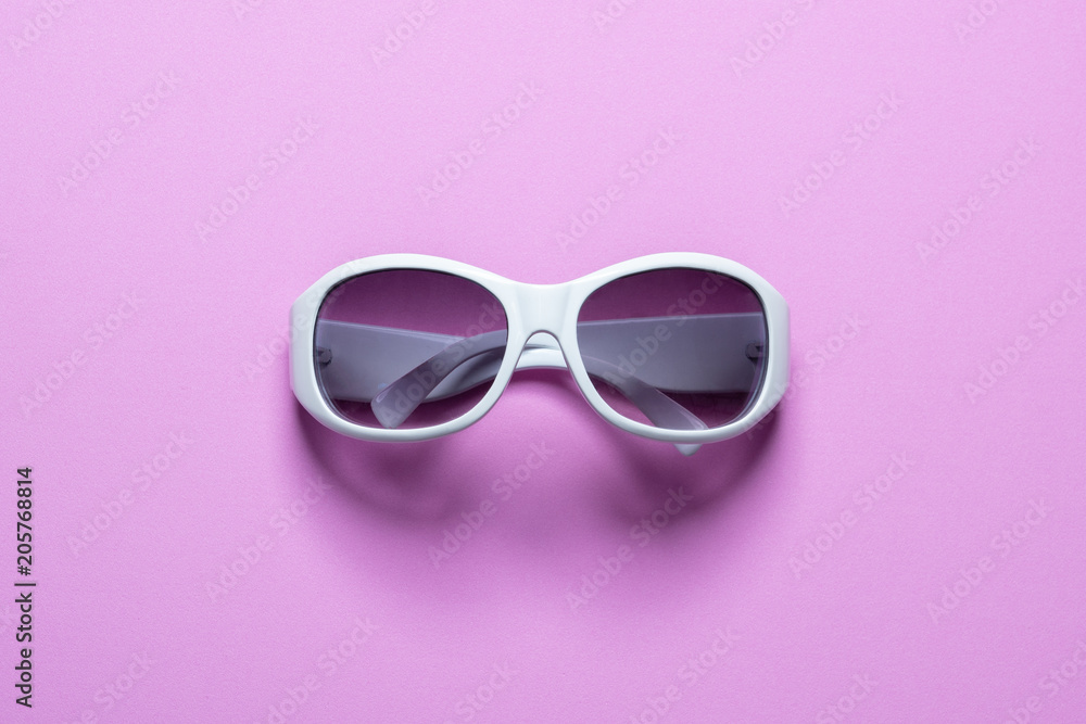 Studio shot of white sunglasses on pink background, Summer is coming concept Studio shot of white sunglasses on pink background, Summer is coming concept