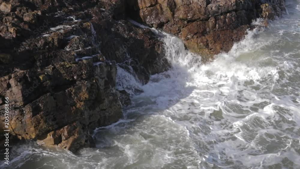 sea waves hitting against rocks sea waves hitting against rocks